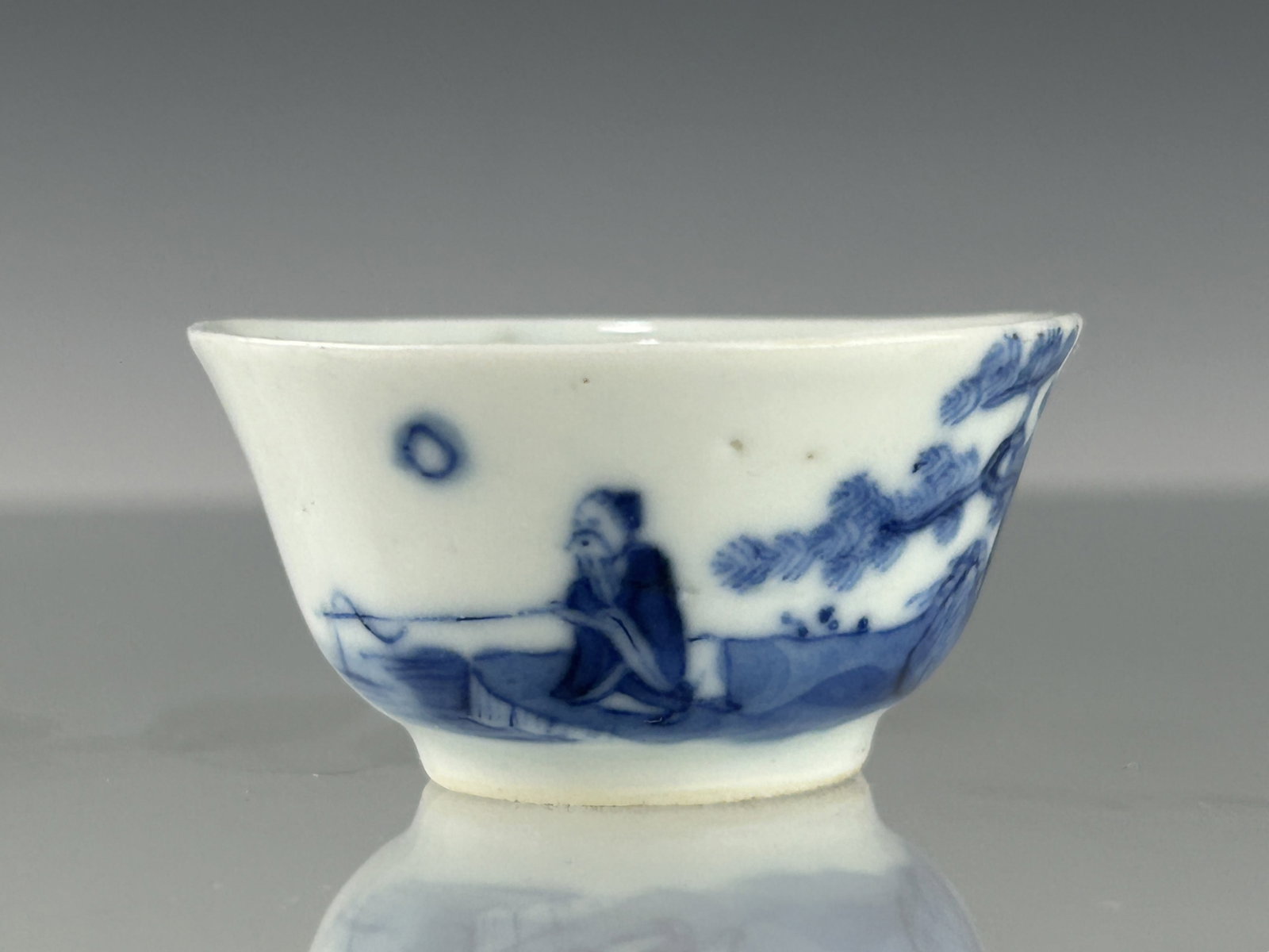 A SMALL CHINESE QING DYNASTY BLUE AND WHITE JIANG TAI GONG FISHING PORCELAIN CUP: Depicting the legendary story of Jiang Ziya (also known as Jiang Taigong), a wise and elderly man who was discovered fishing by the Wei River. Instead of using bait, he used a straight hook, symbolizi