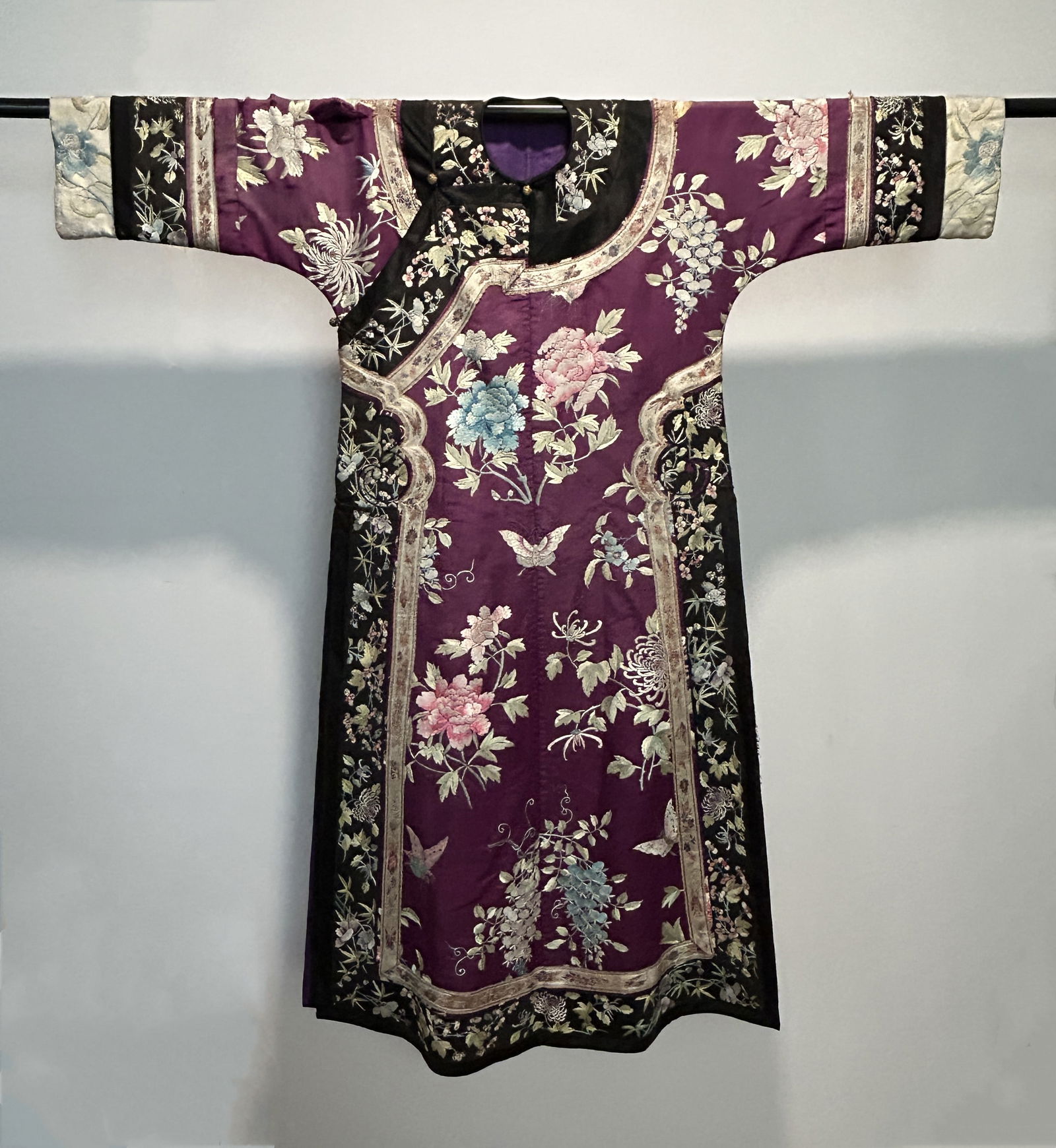 A CHINESE QING DYNASTY PURPLE-GROUND EMBROIDERED SILK FEMALE ROBE (1 of 18)