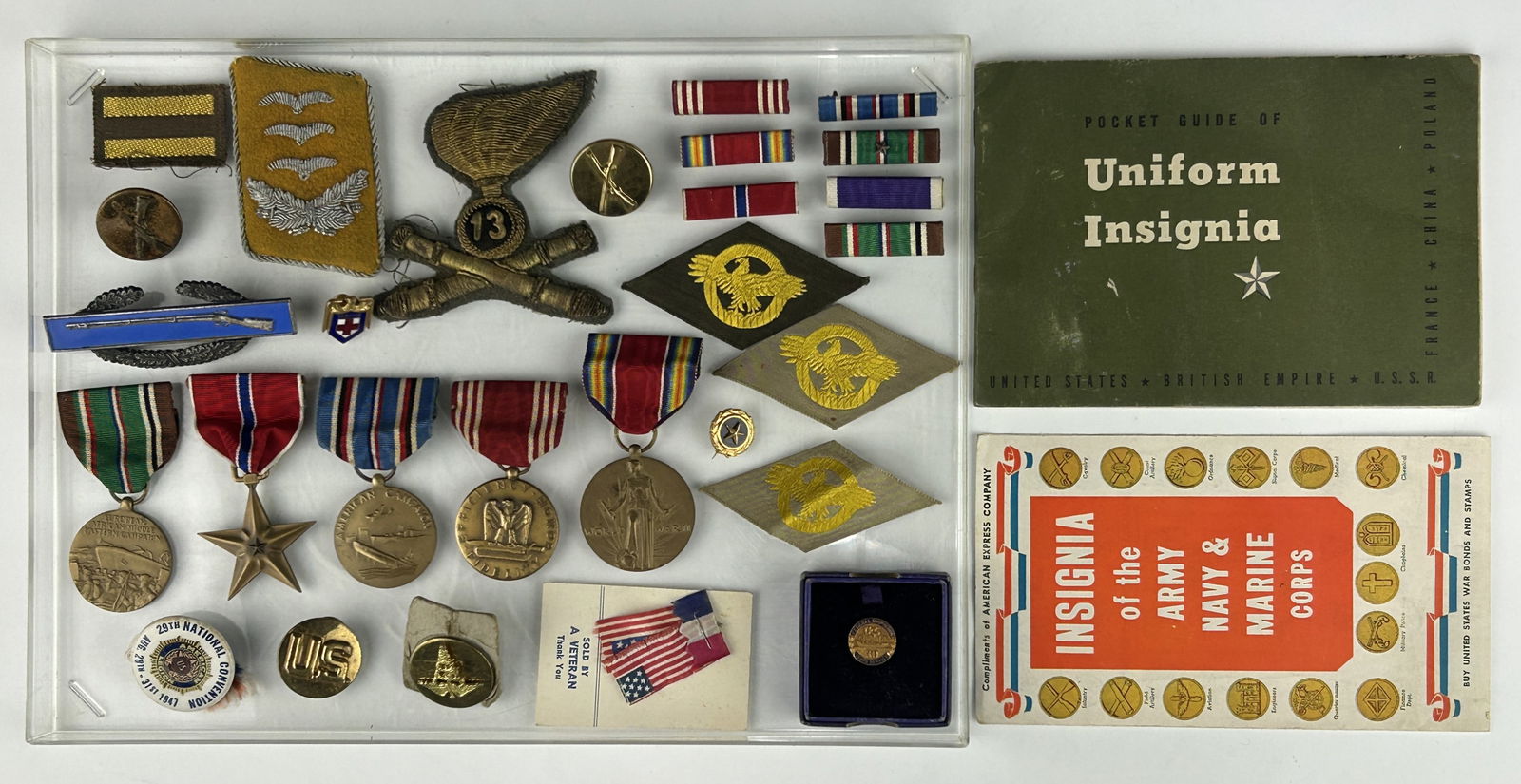 A COLLECTION OF MILITARY MEDALS, INSIGNIAS, PATCHES AND A GUIDE BOOK (1 of 1)