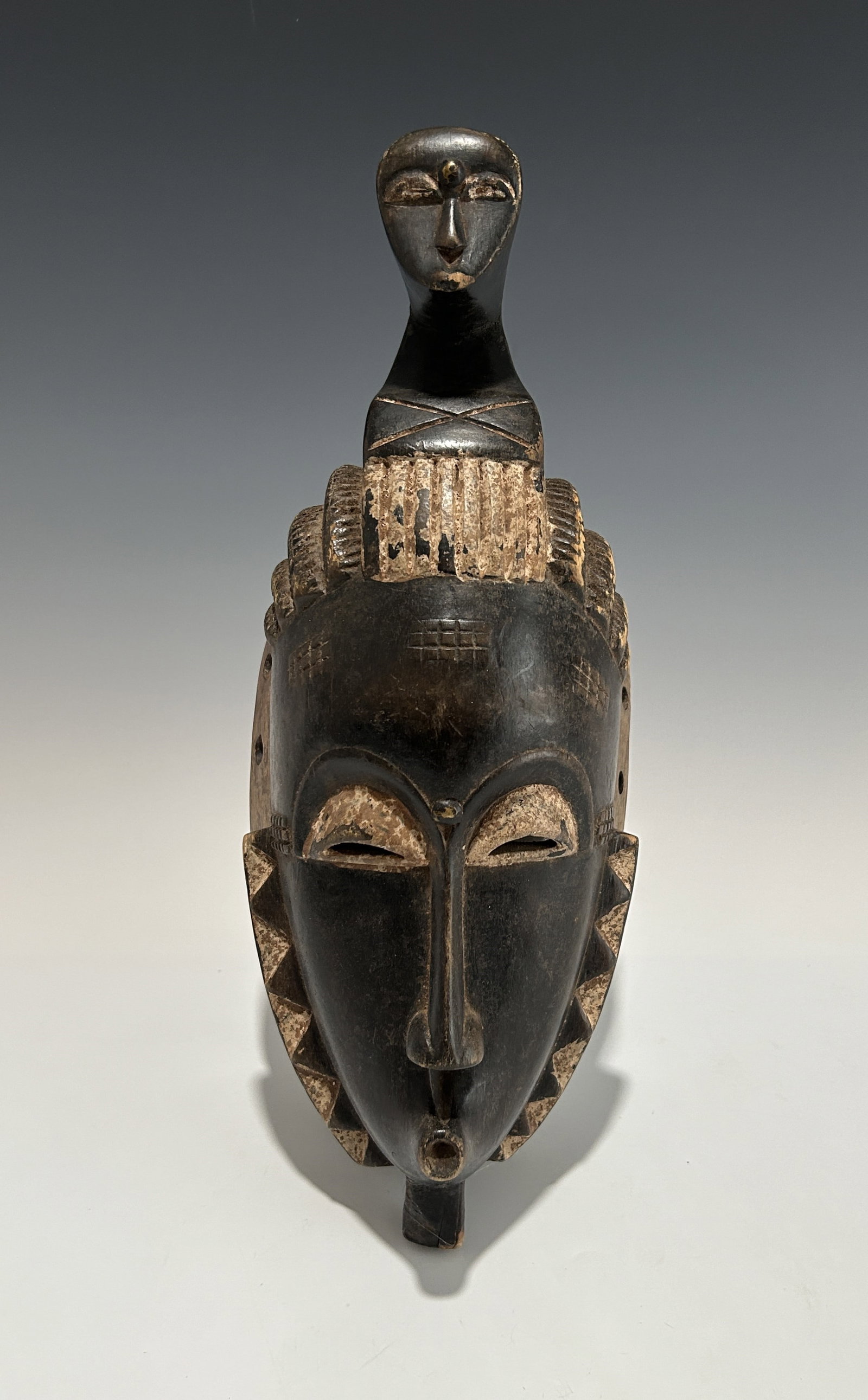 NO RESERVE! AFRICAN IVORY COAST WOODEN BAULE YAOURE MASK: A mid-19th to early 20th century piece. Well-carved, decorated with white Ochre pigment, representing a beautiful young girl's face. In very good vintage condition with aged patina, signs of use and w