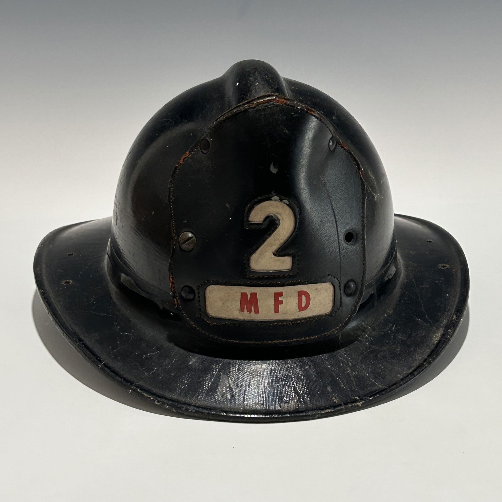 VINTAGE FIREFIGHTER HELMET WITH LEATHER BADGE NUMBER 2 AND MFD & FRC INSIGNIA (1 of 6)