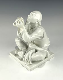 ANTIQUE MEISSEN BLANC DE CHINE PORCELAIN FIGURE OF A SEATED ORIENTAL TAILOR