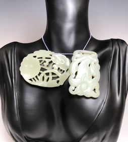TWO ANTIQUE CHINESE CARVED NEPHRITE JADE LOTUS AND LILY PENDANTS
