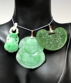 THREE ANTIQUE CHINESE JADEITE AND NEPHRITE JADE PENDANTS