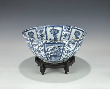 LARGE CHINESE BLUE AND WHITE KRAAK PORCELAIN PUNCH BOWL, MING WANLI PERIOD (1573-1620): An impressive and rare antique Chinese Kraak porcelain bowl. Finely hand-painted in underglaze cobalt blue with alternating panels of floral sprays and auspicious objects around the cavetto and exteri