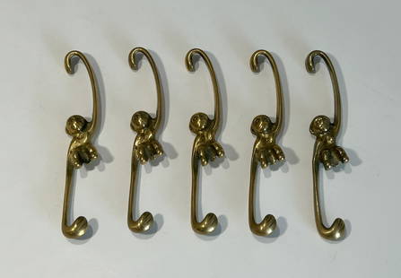 FIVE VINTAGE MID-CENTURY BRASS MONKEY WARDROBE/PLANT HOOKS BY WALTER BOSSE: A charming set of five vintage mid-century brass hooks designed by Austrian artist Walter Bosse. Each whimsical hook depicts a stylized monkey figure with a rounded head, expressive eyes, and outstret