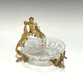 ANTIQUE CHERUB AND BIRD ROCOCO-STYLE METAL STAND AND CUT GLASS TRINKET DISH