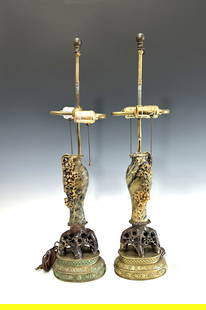 FINE PAIR OF ANTIQUE CHINESE QING DYNASTY SOAPSTONE VASE TABLE LAMPS: Both of the finely carved vases with high-relief grapevine decoration are mounted on elaborate pierced soapstone root-form bases, resting atop tiered brass stands with incised floral patterns and ausp