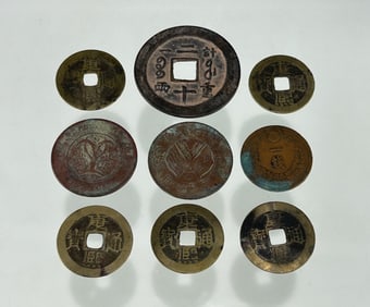 NINE ANTIQUE ASIAN COINS: EIGHT CHINESE AND ONE JAPANESE EXAMPLES