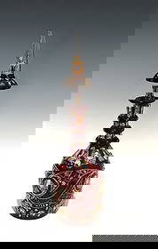 BOHEMIAN RUBY OVERLAY, GILT, AND ENAMELED CUT GLASS DECANTER WITH STOPPER: A finely crafted late 19th-century Bohemian glass decanter, featuring a striking ruby red overlay on clear glass, lavishly decorated with parcel gilt and polychrome enamel work. The decanter presents