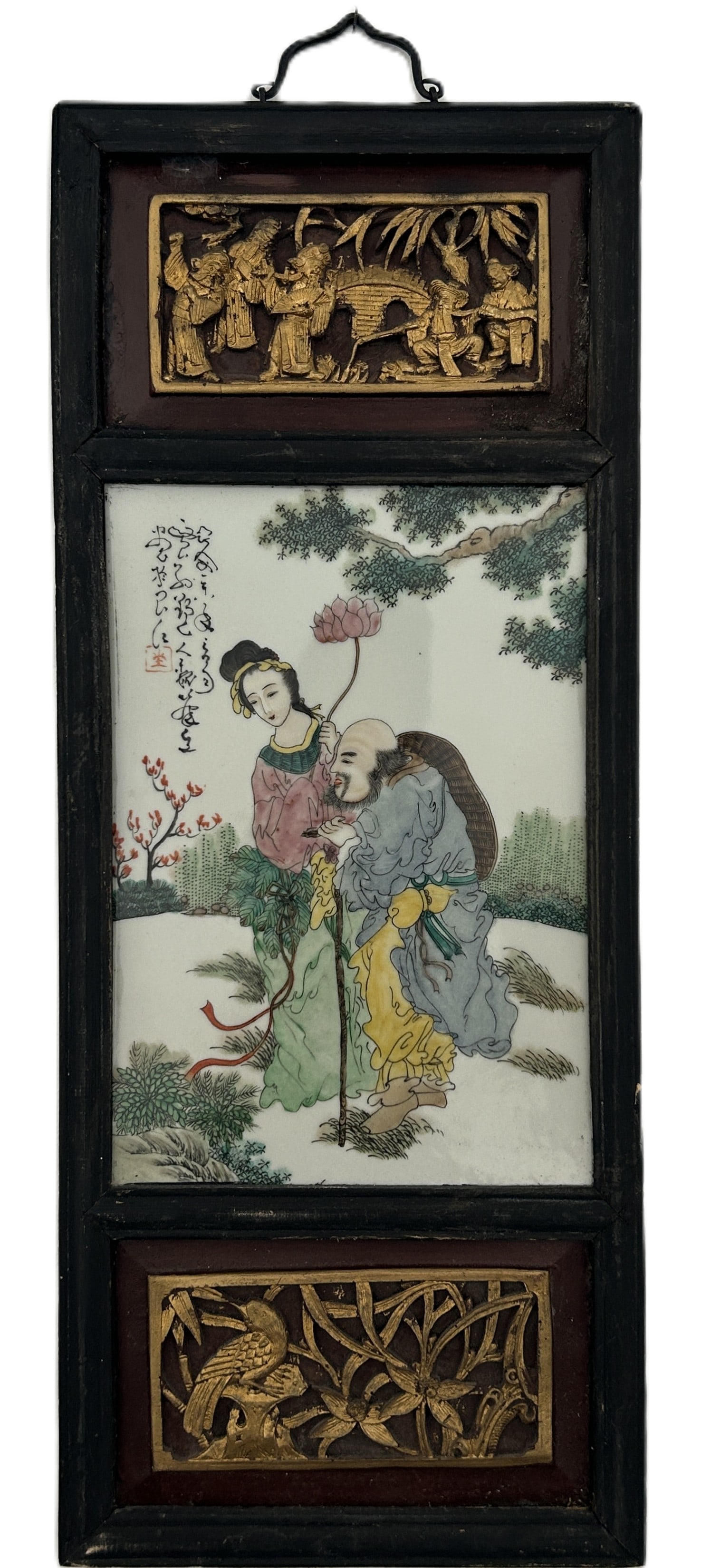 VINTAGE CHINESE FAMILLE ROSE PORCELAIN PLAQUE IN CARVED & GILT WOOD FRAME: Featuring a vibrant painting in the famille rose enamel palette, depicting figures from Chinese folklore or mythology within a serene landscape with lush trees and flora, with calligraphic inscription