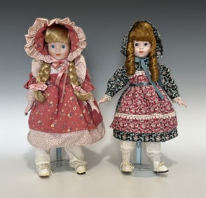 TWO HERITAGE MINT BISQUE HEAD DOLLS IN PRAIRIE COSTUMES, LATE 20TH CENTURY