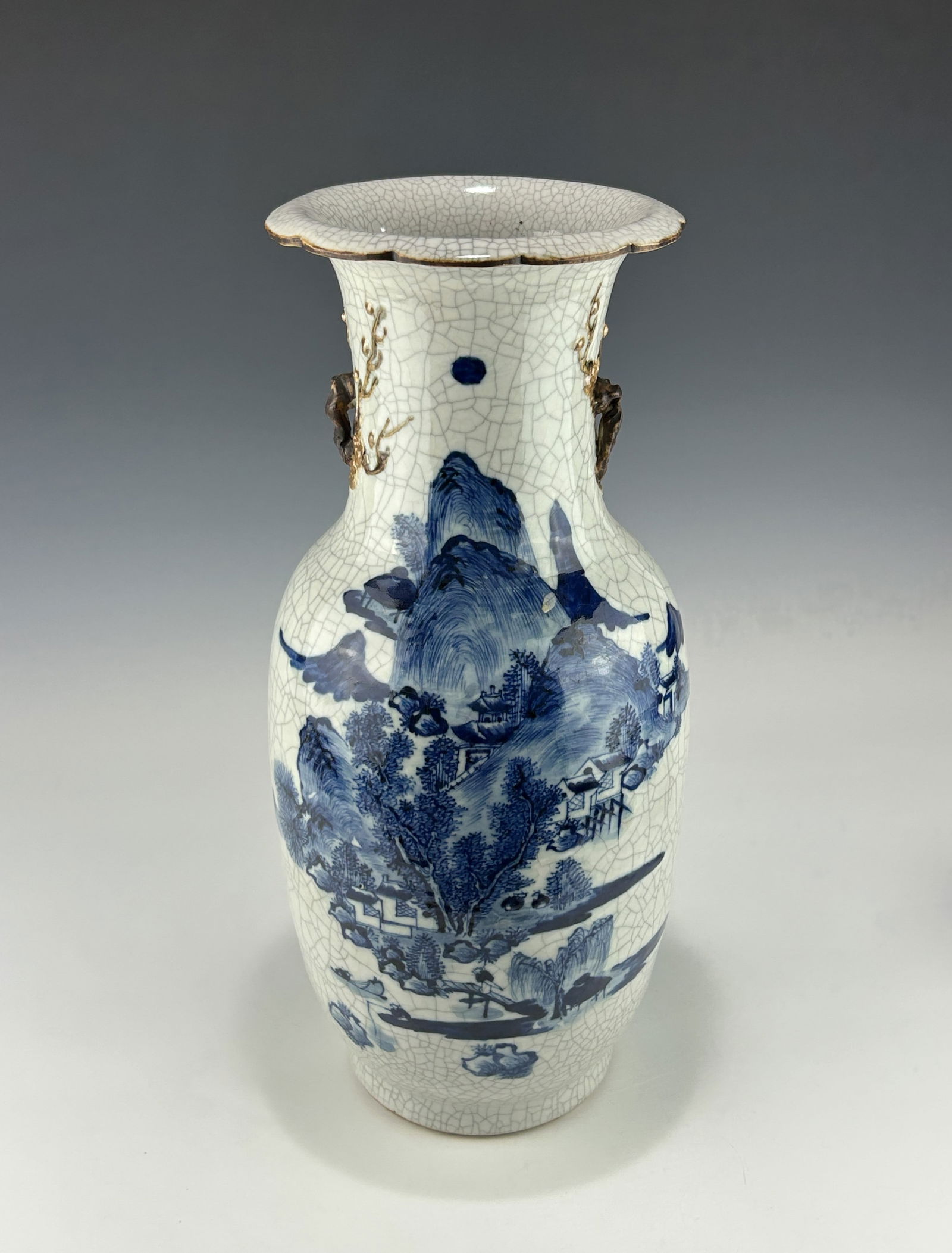 ANTIQUE CHINESE QING BLUE AND WHITE BALUSTER CRACKLE-GLAZED VASE: Late 19th century, with a continuous landscape scene, featuring a mountainous riverside village with traditional architecture, pine trees and figures, all executed in a literati influence style. The n