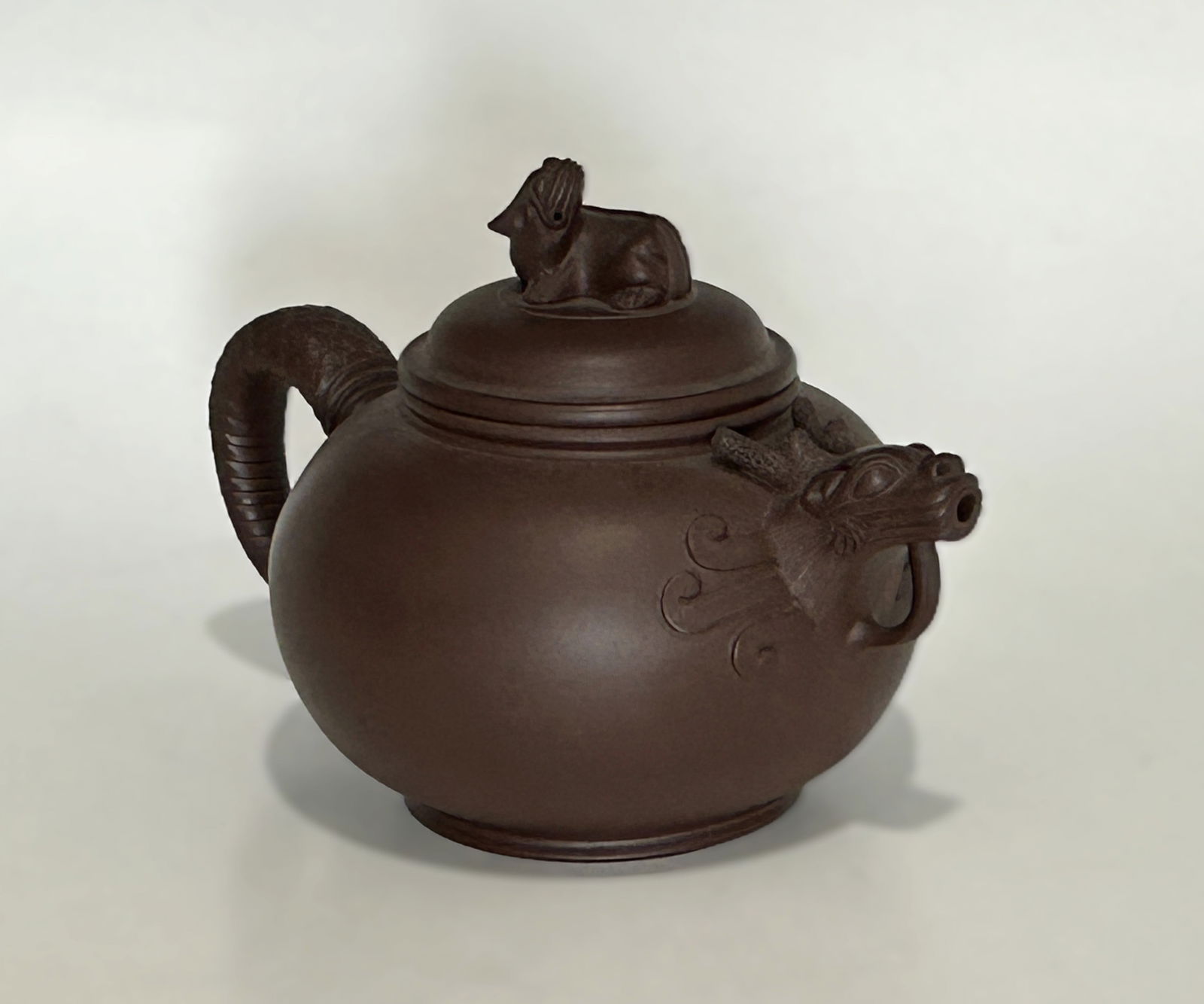 VINTAGE CHINESE YIXIN ZISHA TEAPOT BY MASTER SHI GUO PING: Vintage Chinese Yixing zisha teapot of rounded form with animal finial lid and sculptural animal-head spout. Interior lid and base impressed with Chinese seal marks. Dark brown zisha clay with smooth