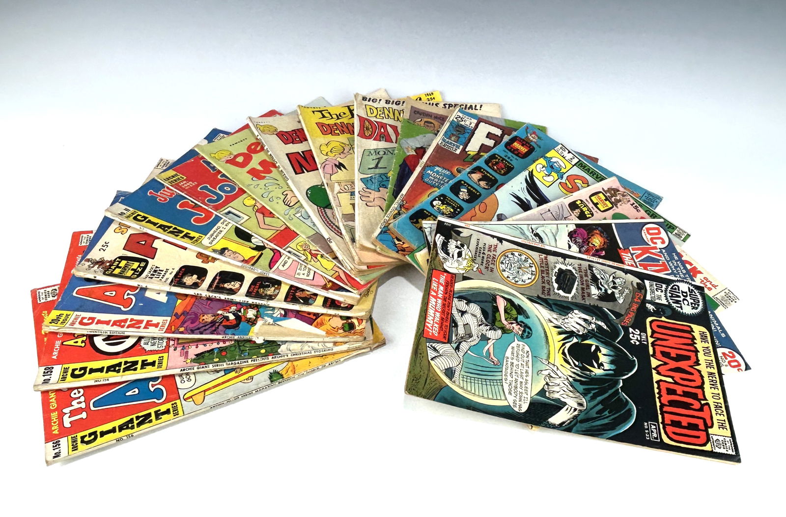 ASSORTED VINTAGE COMIC BOOKS: ARCHIE GIANT SERIES, DENNIS THE MENACE, MARVE, HARVEY AND SUPER DC: A diverse collector's lot featuring 16 vintage comic books spanning the late 1960s to the early 1970s. This collection offers a mix of genres, from classic teen humor to supernatural horror and superh