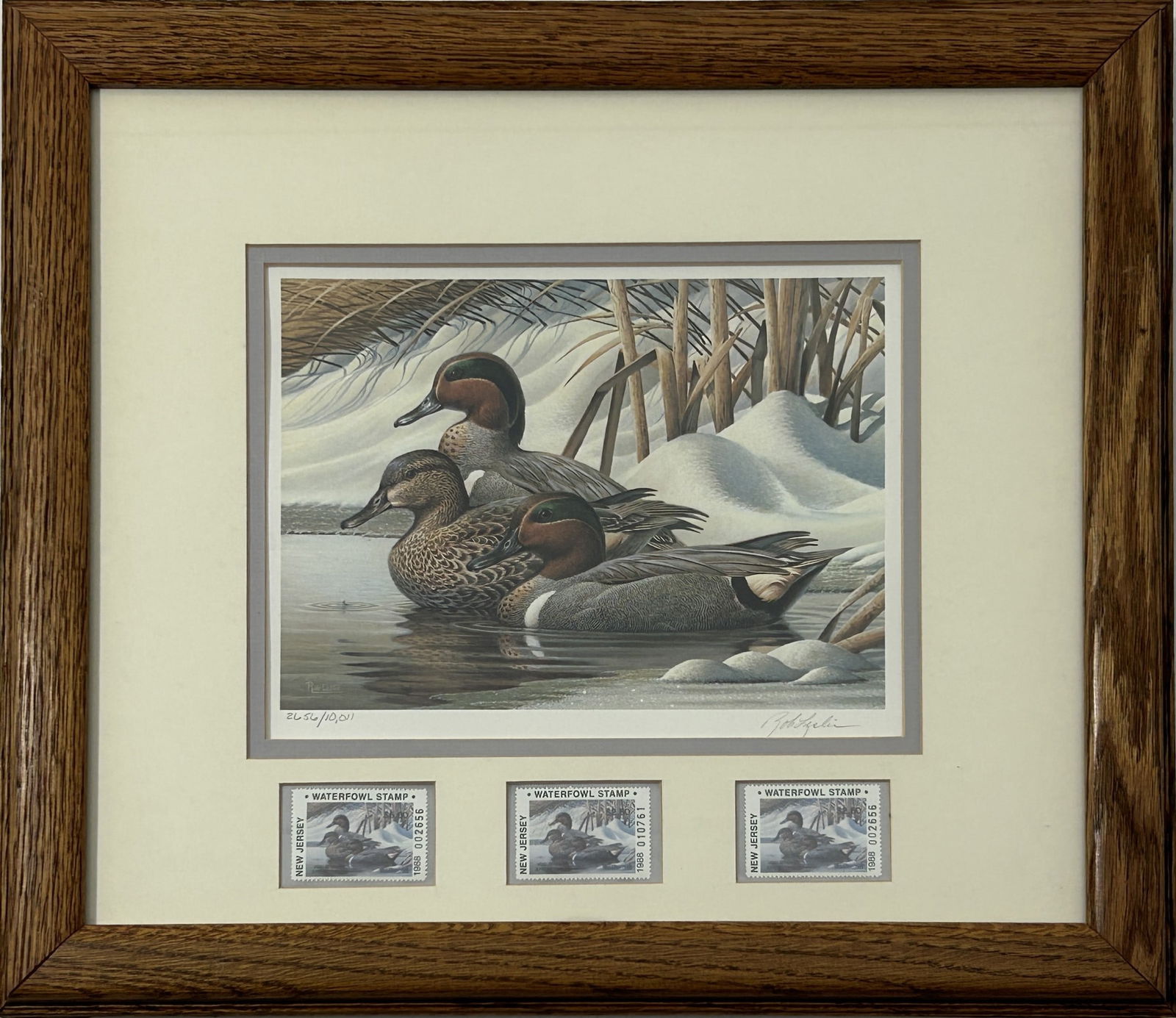 1988 NEW JERSEY WATERFOWL STAMP & PRINT BY ROB LESLIE: Limited edition featuring three ducks swimming in the water next to snowy landscape. Print numbered upon the lower left and signed upon the lower right by the artist in pencil. Three stamps present. B