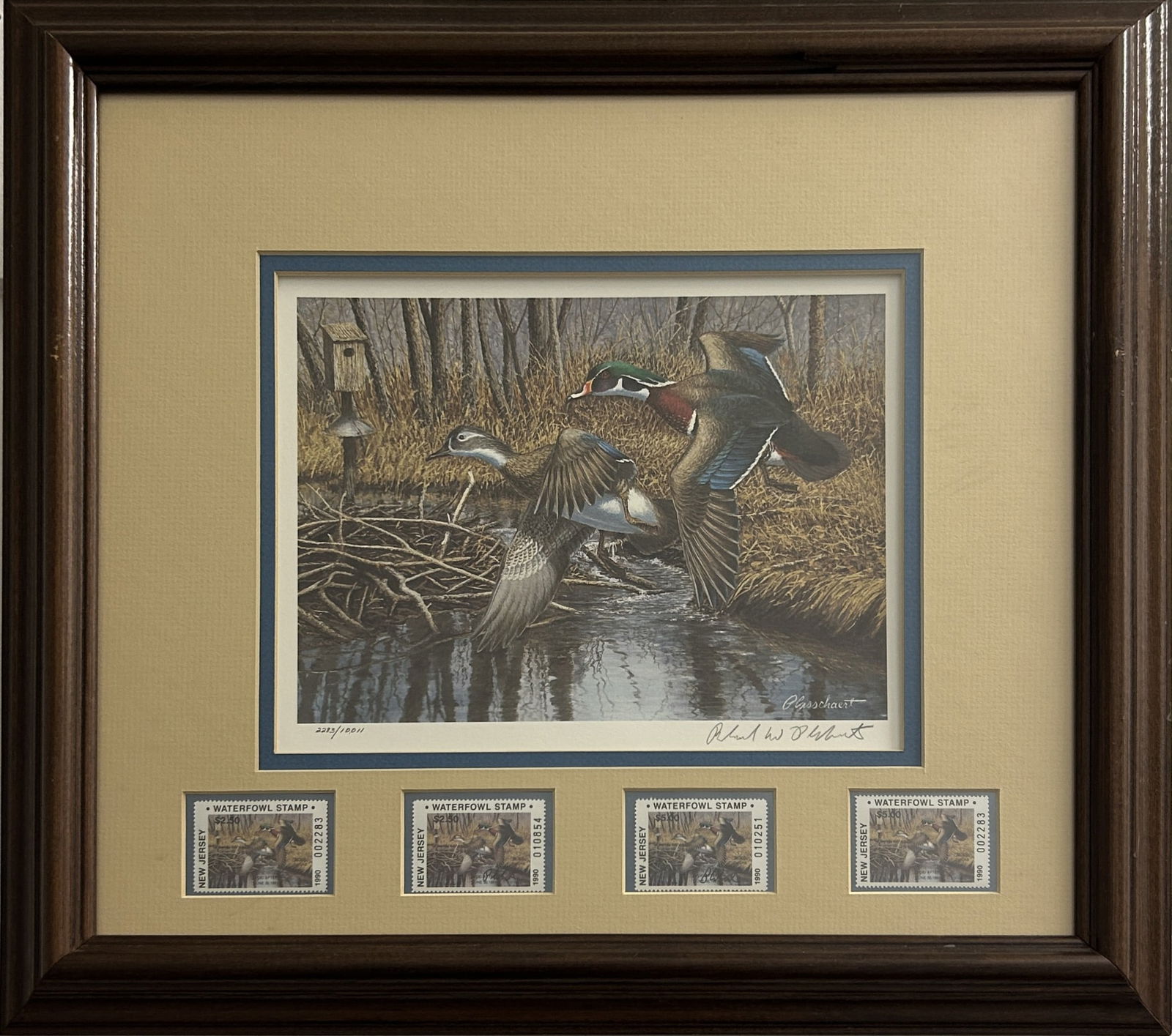 1990 NEW JERSEY WATERFOWL STAMP & PRINT BY RICHARD PLASSCHAERT: Limited edition print depicting wood ducks in flight descending into a wooded marsh setting. Four 1990 New Jersey Waterfowl stamps are mounted beneath the print. The print and stamps are professionall