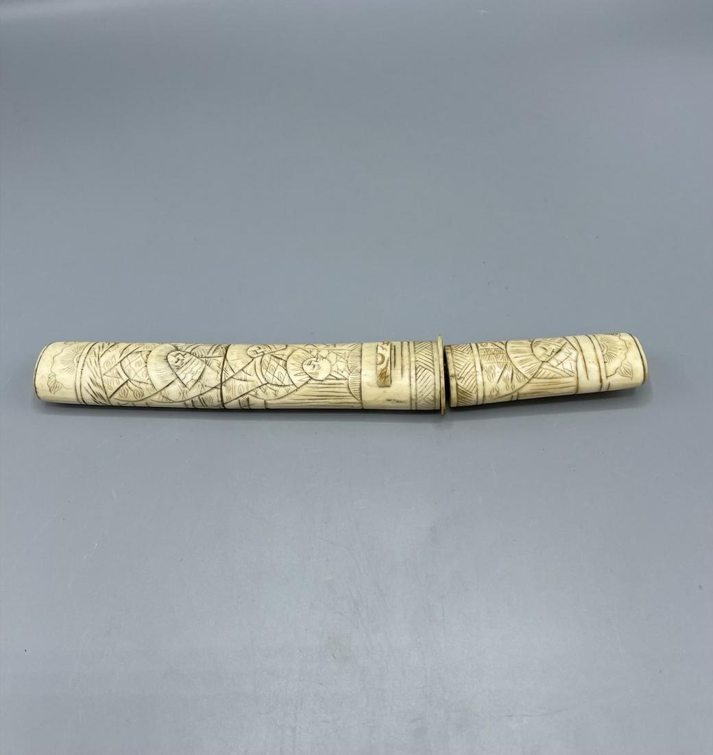 A Japanese knife: A Japanese knife with carved bone handle and case, Japan ca. 1900. total length with case ca.25 cm