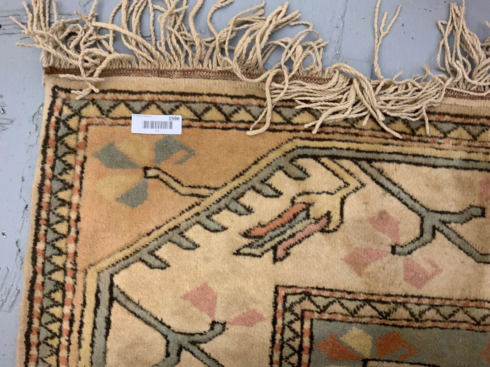 Large hand knitted wool rug: Large hand knitted wool rug in light brown blue and rose colors all in all in good shape some spots or minor discolorations on rug, approximate size, 80 inches wide by and 108 inches long.