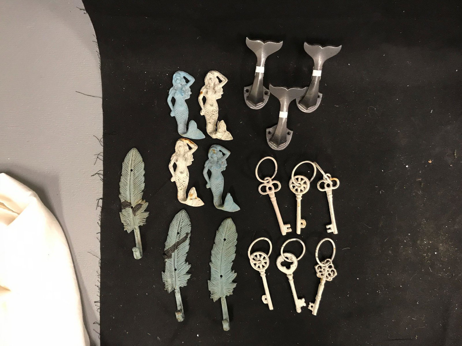 Decorative Hooks and Keys: Decorative mermaid hooks, whale tail hooks, and feather hooks. Includes six decorative white keys. Includes crate for transportation.