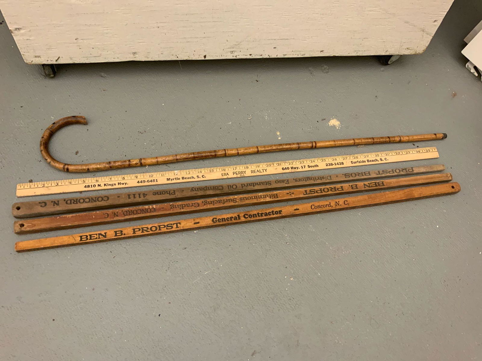 One antique bamboo cane and 4 yard sticks: One antique bamboo cane and four yardsticks advertising pieces three of the yard sticks are the square size with hanging holes 3 of them say Ben B Prospst general contractor Concord North Carolina, Th