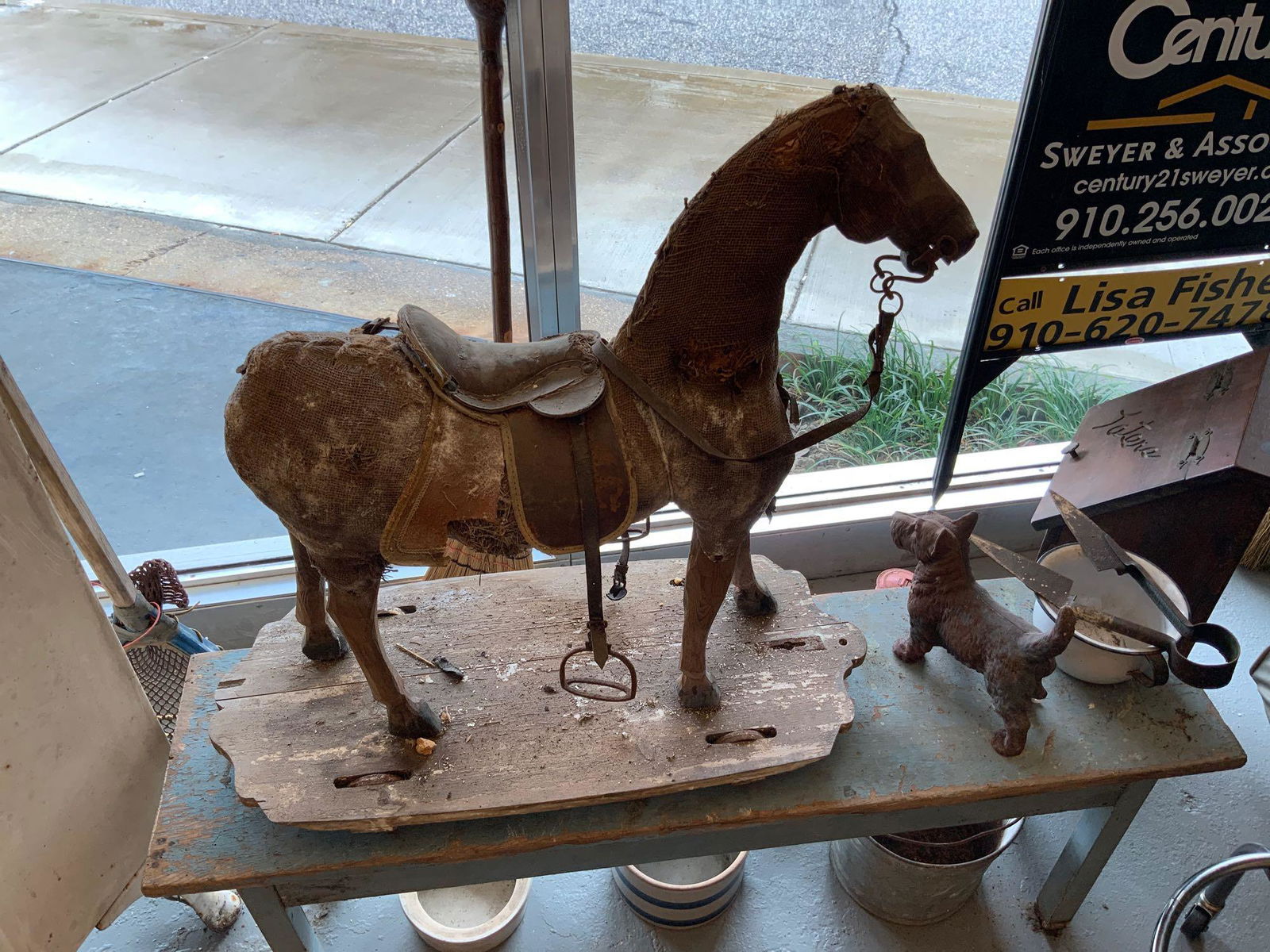 Antique child’s horse on wheels in a wood: Antique child’s horse on wheels and a wood platform in rough condition but still nice looking display piece my guess is late 1800s, Head and legs are handcarved wheels are still on cart..