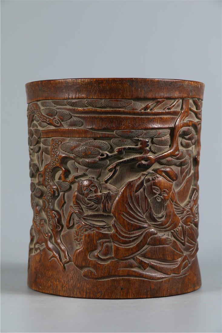 A HUANGHUALI WOOD BRUSH POT: Huanghuali Wood Brush Pot with Pine Tree and Old Man Pattern, Qing Dyn.
