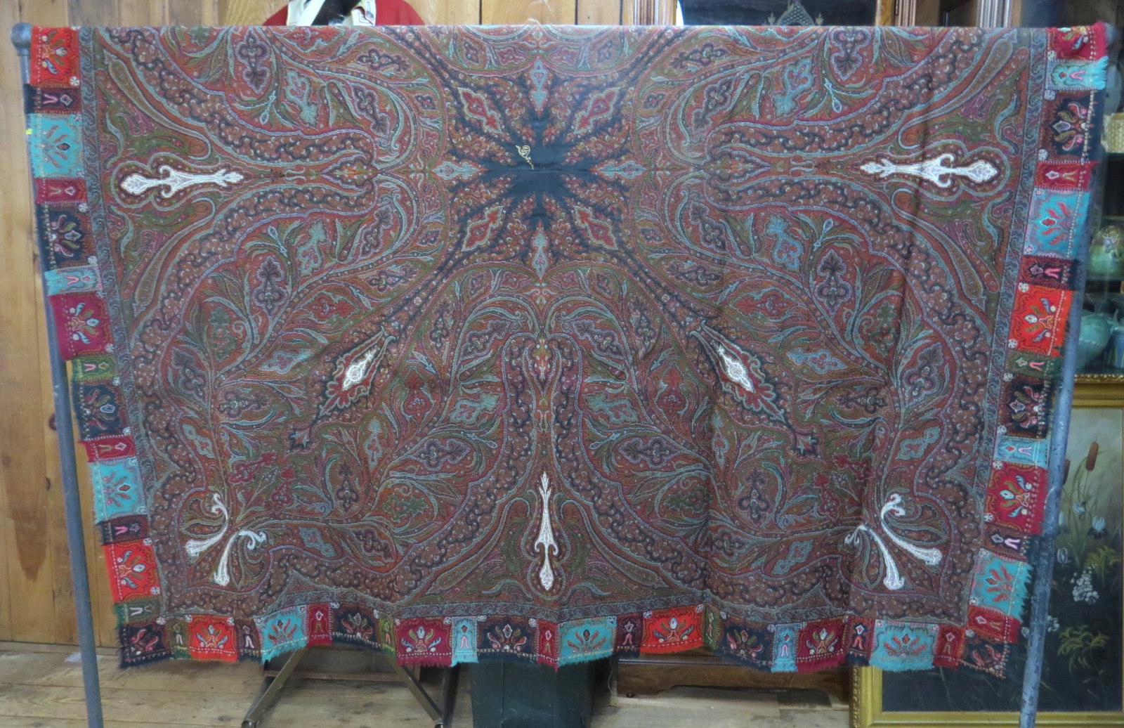 Paisley shawl: Paisley shawl with black center medallion, block border and dark field with white patches, signed in center medallion, 69” x 68”