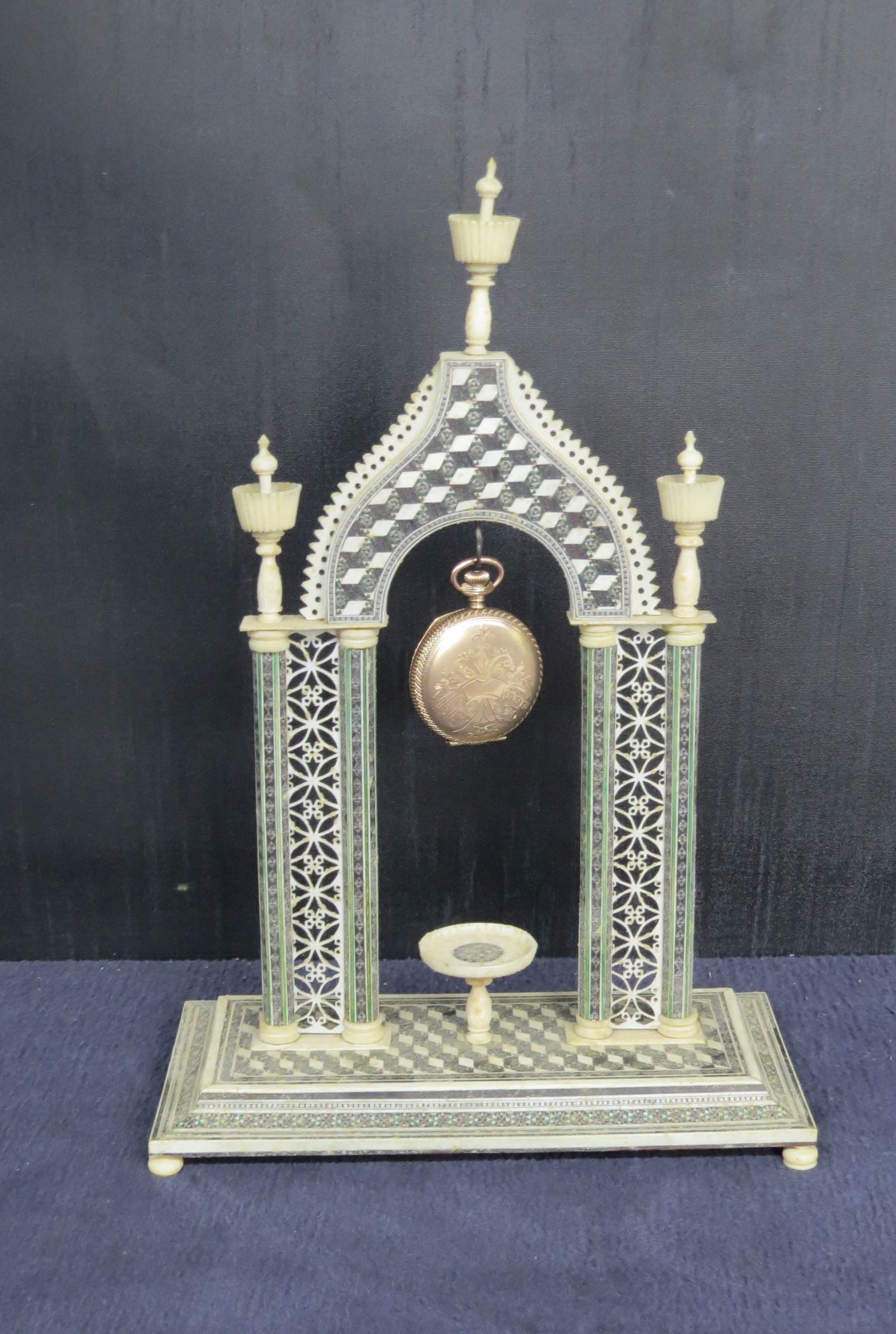 Micro mosaic inlaid bone watch holder: Micro mosaic inlaid bone watch holder, base is 7 ¾” x 3 ¾” and stands 11 ½” h. very good condition, has one foot replaced. Does not include watch.