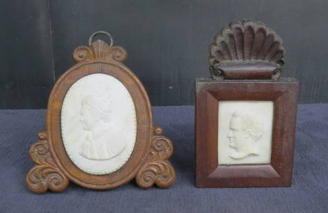 Two carved wooden dresser frames: Two carved wooden dresser frames holding marble relief portraits, one oak oval frame with carved feet and crest 5 &frac12;&rdquo; x 5 &frac12;&rdquo; has carved marble bust of a woman, mahogany frame