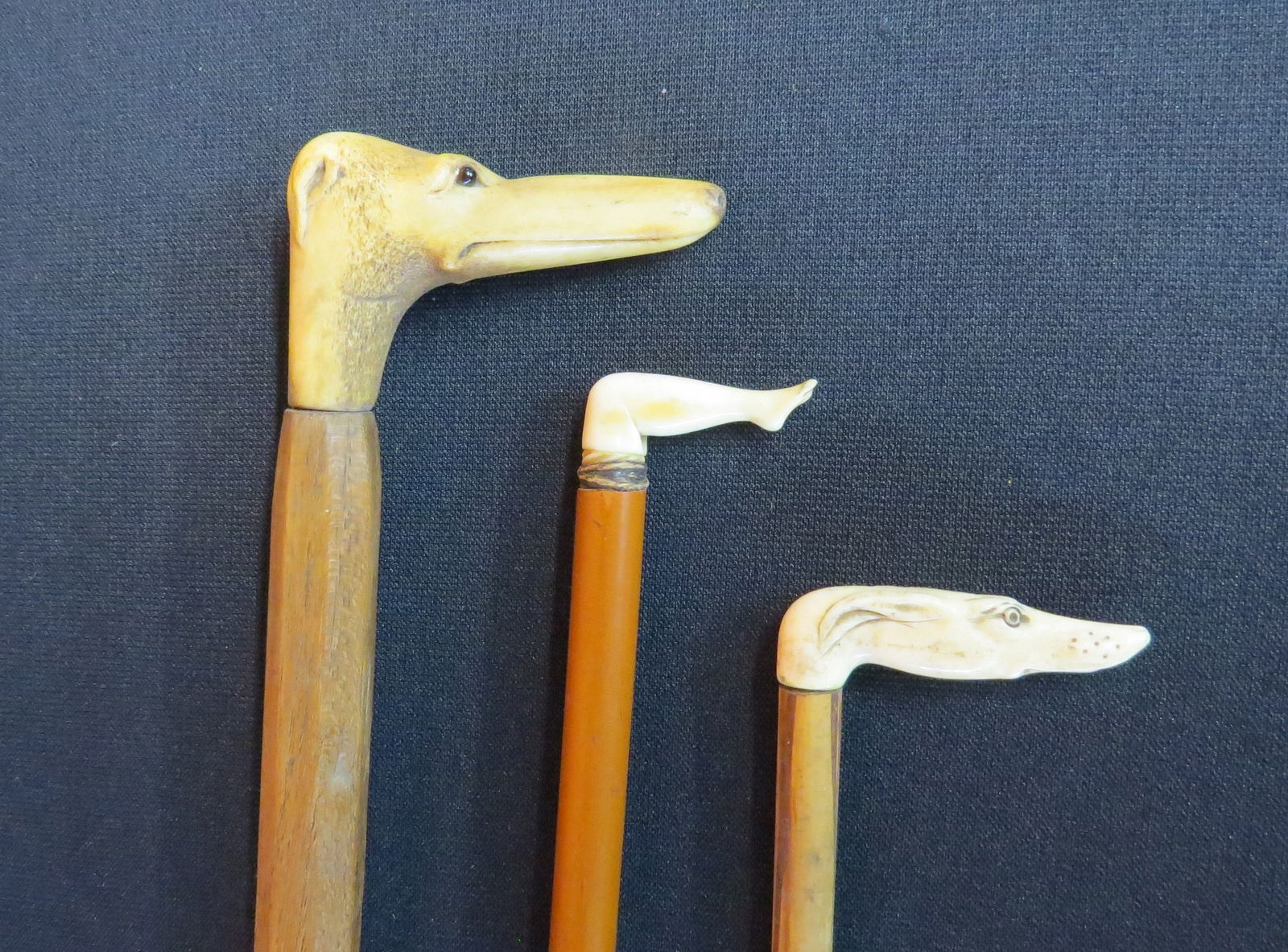 Lot 3 carved bone handle canes: Lot 3 carved bone handle canes, dog head 34 ½”, carved woman’s leg 34 ½” and dog head 28 ½”, good condition