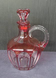 Cranberry to clear American Brilliant cut glass  overlay whiskey jug: Cranberry to clear American Brilliant cut glass overlay whiskey jug with applied handle, panel cut with notched handle, 8&rdquo; h. excellent condition