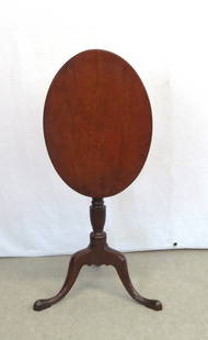 Mahogany oval tilt top candle stand: Mahogany oval tilt top candle stand possibly Newburyport, Joseph Short, open 39 &frac12;&rdquo;, down 28&rdquo; h. top is 21 &frac34;&rdquo; x 15 &frac34;&rdquo;, pedestal has urn turning, snake feet