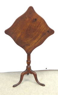 Mahogany tilt top stand with shaped top: Mahogany tilt top stand with shaped top, scalloped top has fiery mahogany grain, squatty urn pedestal over Queen Ann snake feet with pad, under side has metal plate and handmade nails holding legs in