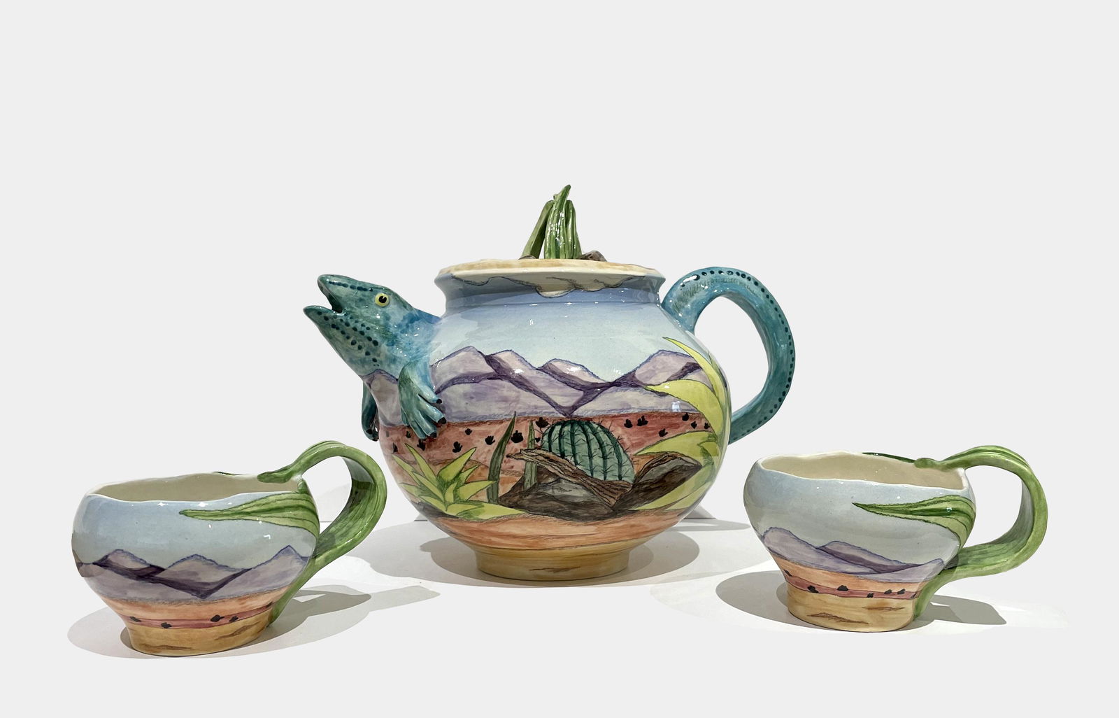 Elaine Bolz: Desert Motif Tea Set (Teapot and 2 Tea Cups); c. 2000; Hand Painted Porcelain; 8.5" x 11" (teapot) / 3" x 5" (tea cups); Signed on Bottom (each).