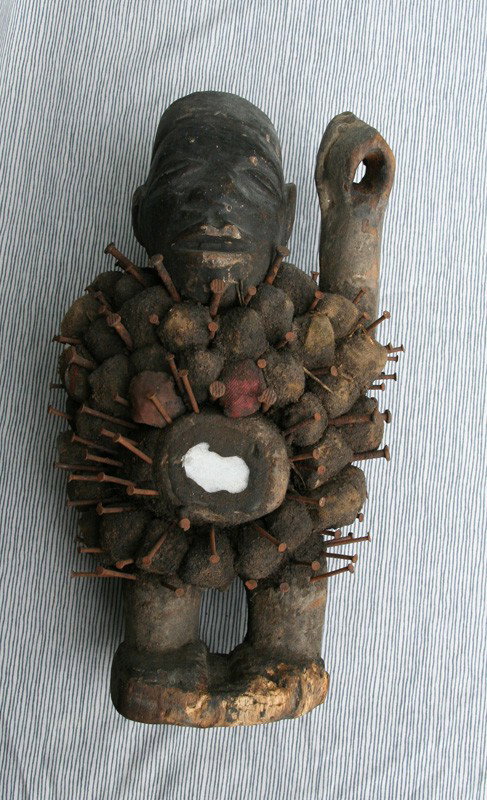 Lot of Two: African Fetish Figures: African; A.Carved Wood, Trade Cloth, Iron Spikes & Mirror; B. Sharp instruments embedded in figure symbolize the ability to retain pain and repel negative forces by the power of ancestral protection. 