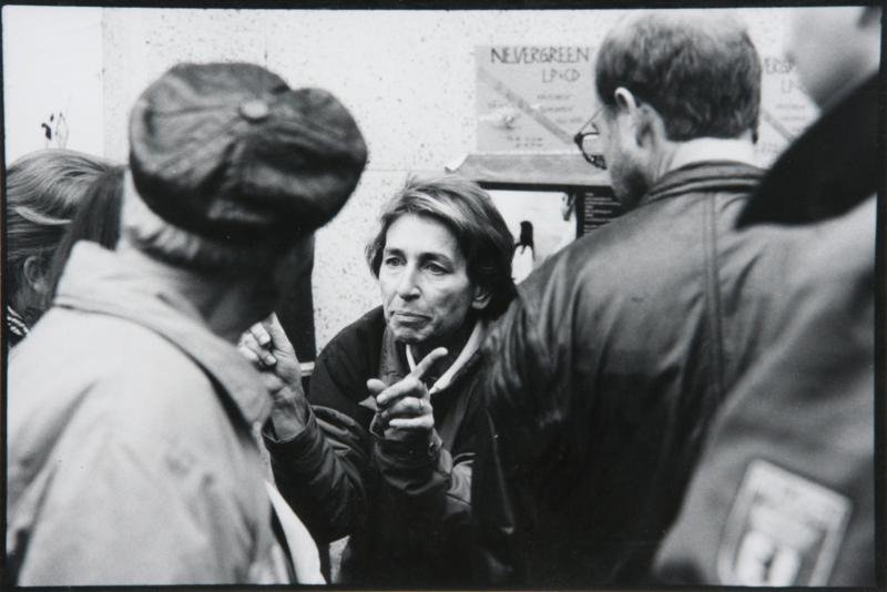 Vincent Cianni (20th Century): The Residents of Maunzerstrasse Quarters Discussing Police Battle with Berlin; 1990; Silver Gelatin Print; 8.5 x 12.5"; Label on verso; Framed. May be signed or studio stamped under mat. Exhibition la
