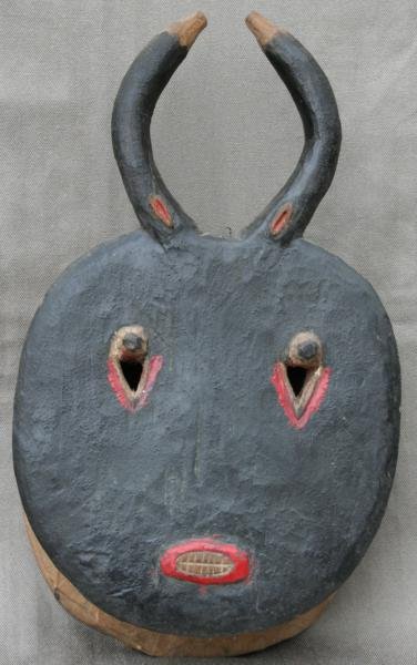 Unknown West African: Carved Wood Mask; Plychromed Wood; 16" H x 10" W x 4.5" D. This simple, authentic, well worn tribal mask was collected by a Peace Corp volunteer in the 1960's. Was old when purchased.