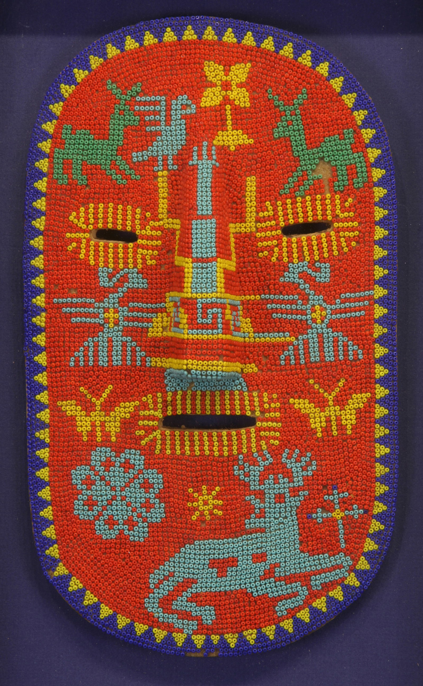 Vintage Mexican Huichol Folk Art Beaded Mask: Vintage Mexican Huichol Folk Art Beaded Mask; n.d.; Beads Mounted on Wood with Beeswax; 11.25" x 6.5"; Unsigned; Framed (under glass).