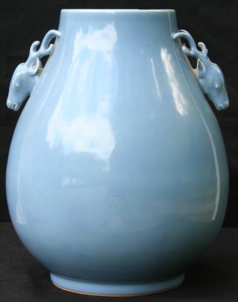 Qianlong Mark, Late Qing Dynasty: Chinese Monochrome Porcelain Hu Vase, Qianlong Mark, Late Qing Dynasty, 14" H, Signature N/A. The large light blue vase with deer-head handles of typical form.