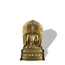 A gilt-bronze statue of Medicine Buddha