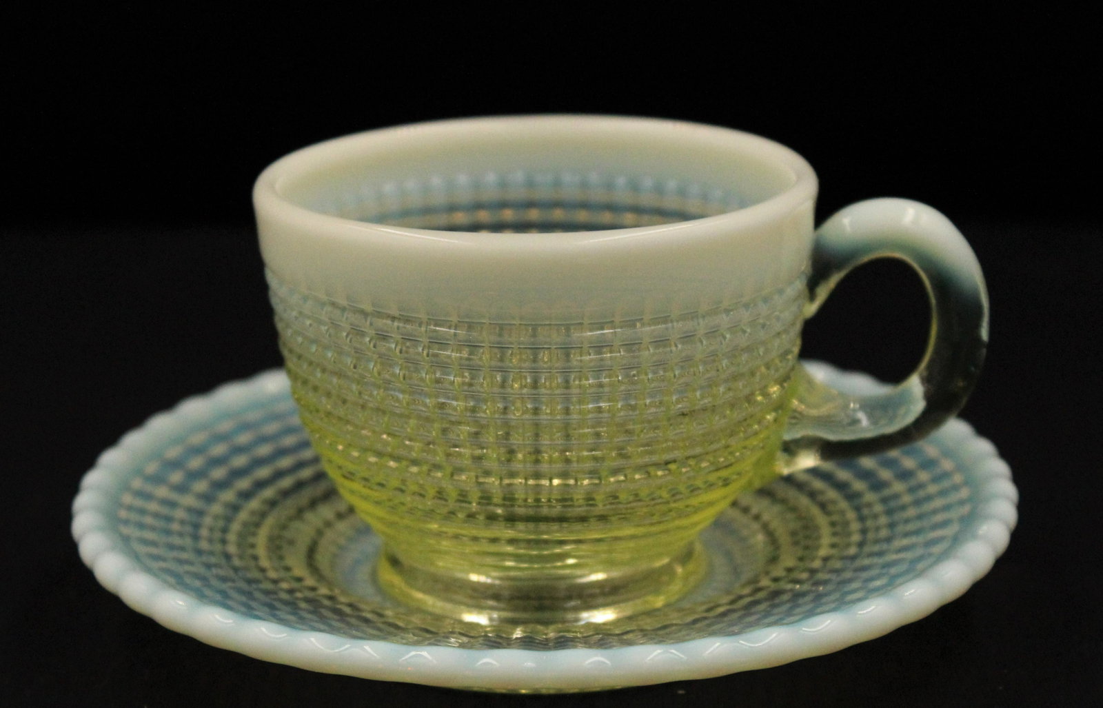 Scarce Vaseline Opalescent Cup and Saucer: Scarce Victorian Model Flint Albany Glass Ribbed Sprial pattern cup and saucer. Cup measures 2 1/4" H, 4" W. Saucer is 5 1/4" D.