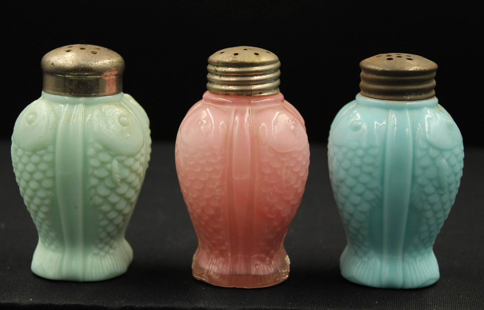 3pc. Lot Victorian Fostoria Consolidated Fish Shakers: 3pc. Lot of Fostoria Consolidated Victorian Fish form shakers. Green and blue opaque and a cased pink. Each measures 3 1/2" H.