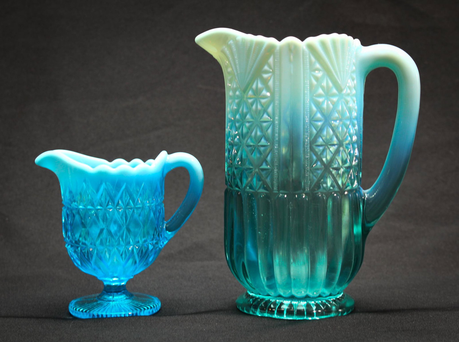 Lot of Davidson Blue Opalescent Pitcher & Creamer: Lot of 2 pieces of davidson Blue opalescent glass to include a pitcher and creamer. Pitcher measures 7 3/8" tall. Creamer measures 3" tall. Condition: Excellent