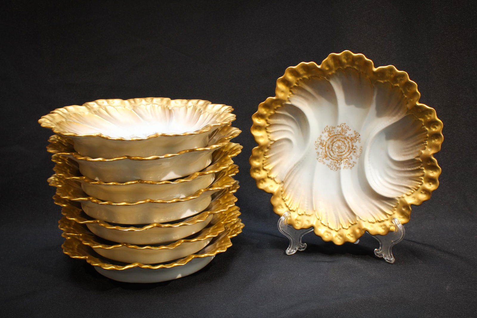 8pc setting of French Gilt Porcelain Plates: Beautiful Victorian set of French in origin scalloped edge plates. Marked as shown. Beautifully embellished with lots of gold and intricate molded relief, these are amazing. Each measures 9 1/2" in di