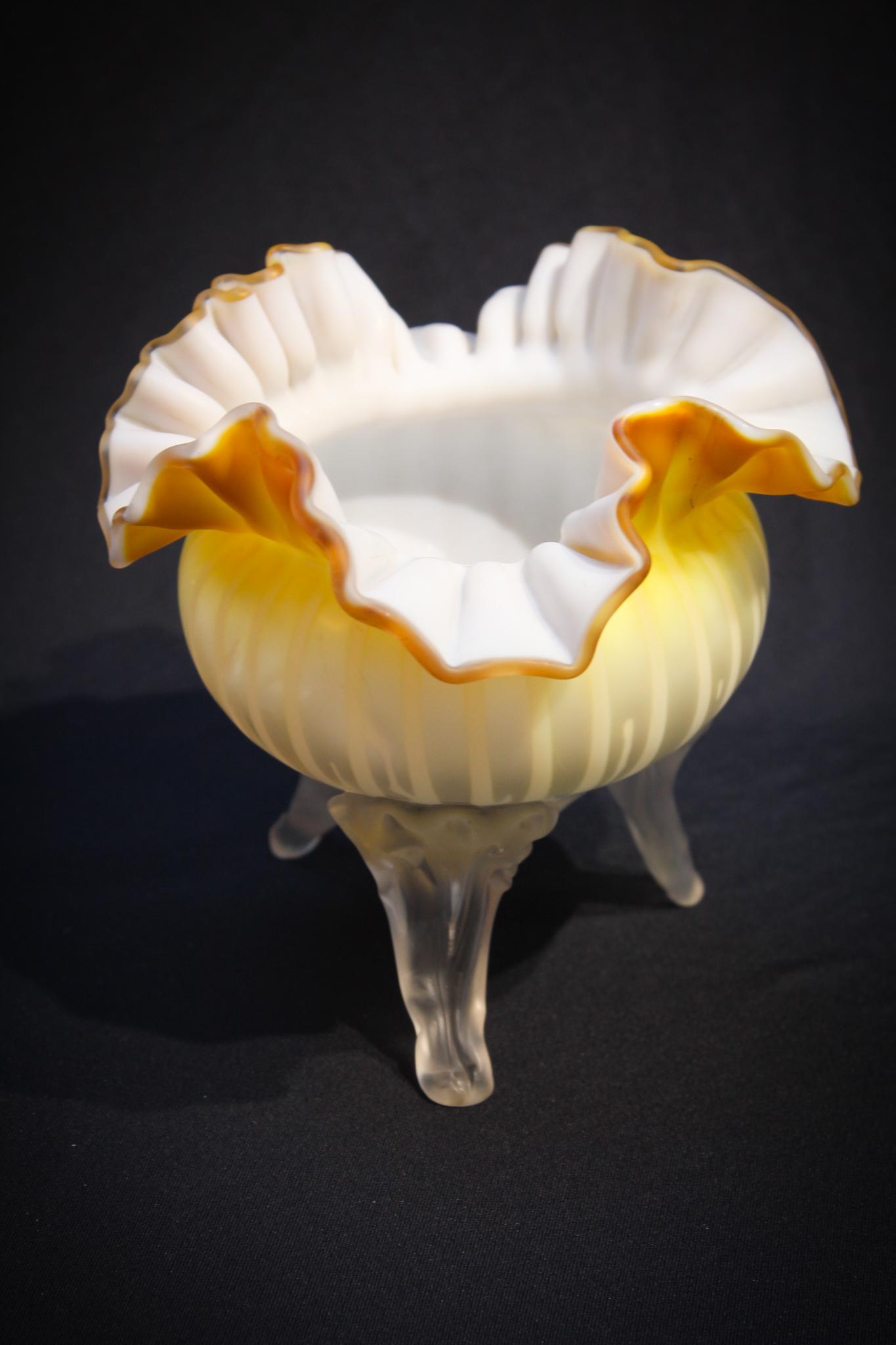 Rich Burnt Lemon Stripe Mother of Pearl Glass Vase: This is so unusual. Color we refer to as burnt lemon. Vase has 3 applied feet and a vertical stripe mother of pearl airtrap pattern. Very nice piece for you satin glass collection. Measures 6" tall.