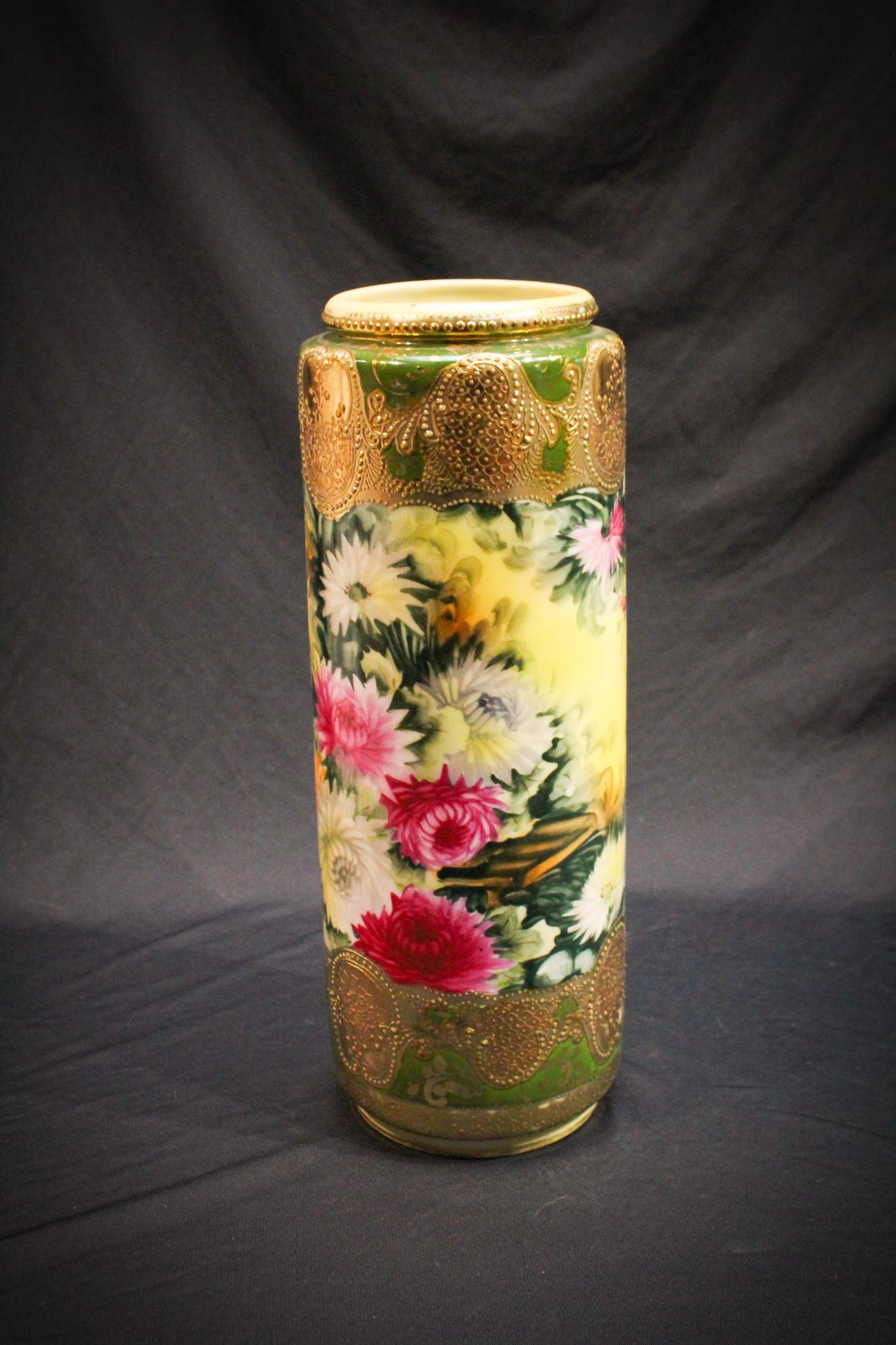 Nippon Chrysanthemum Cylinder vase: Chrysanthemums decorate this lovely. All over dÃ©cor of various colored mums on this extraordinary example. Signed nippon. Measures 12 1/4" high.