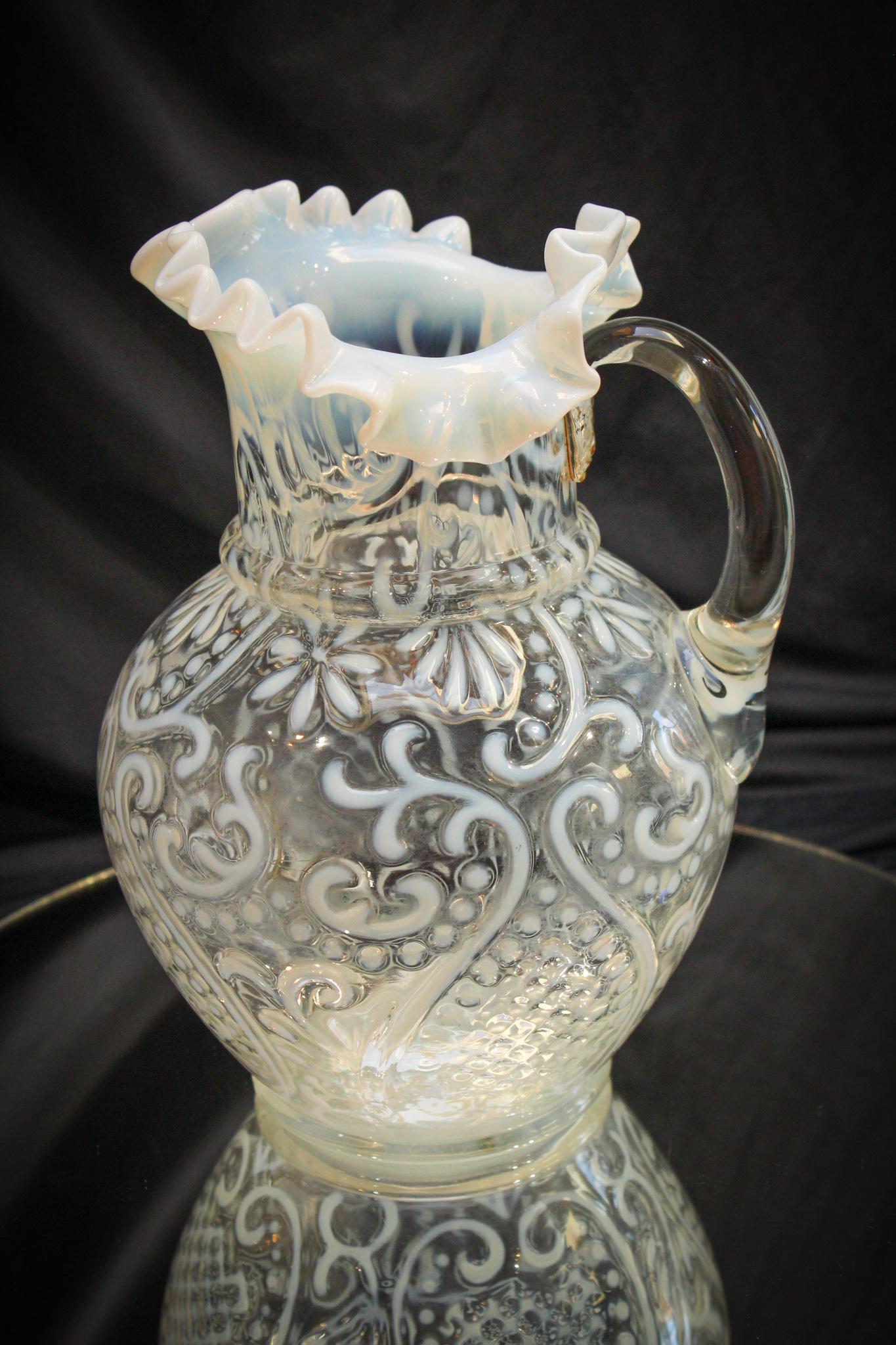 Scarce Opalescent Arabian Nights Water Pitcher: Now you see them in blue and cranberry but seldom ever in white opalescent. This example is fantastic as far as clarity to the glass and the striking opalescence. Measures 9 1/2" tall.