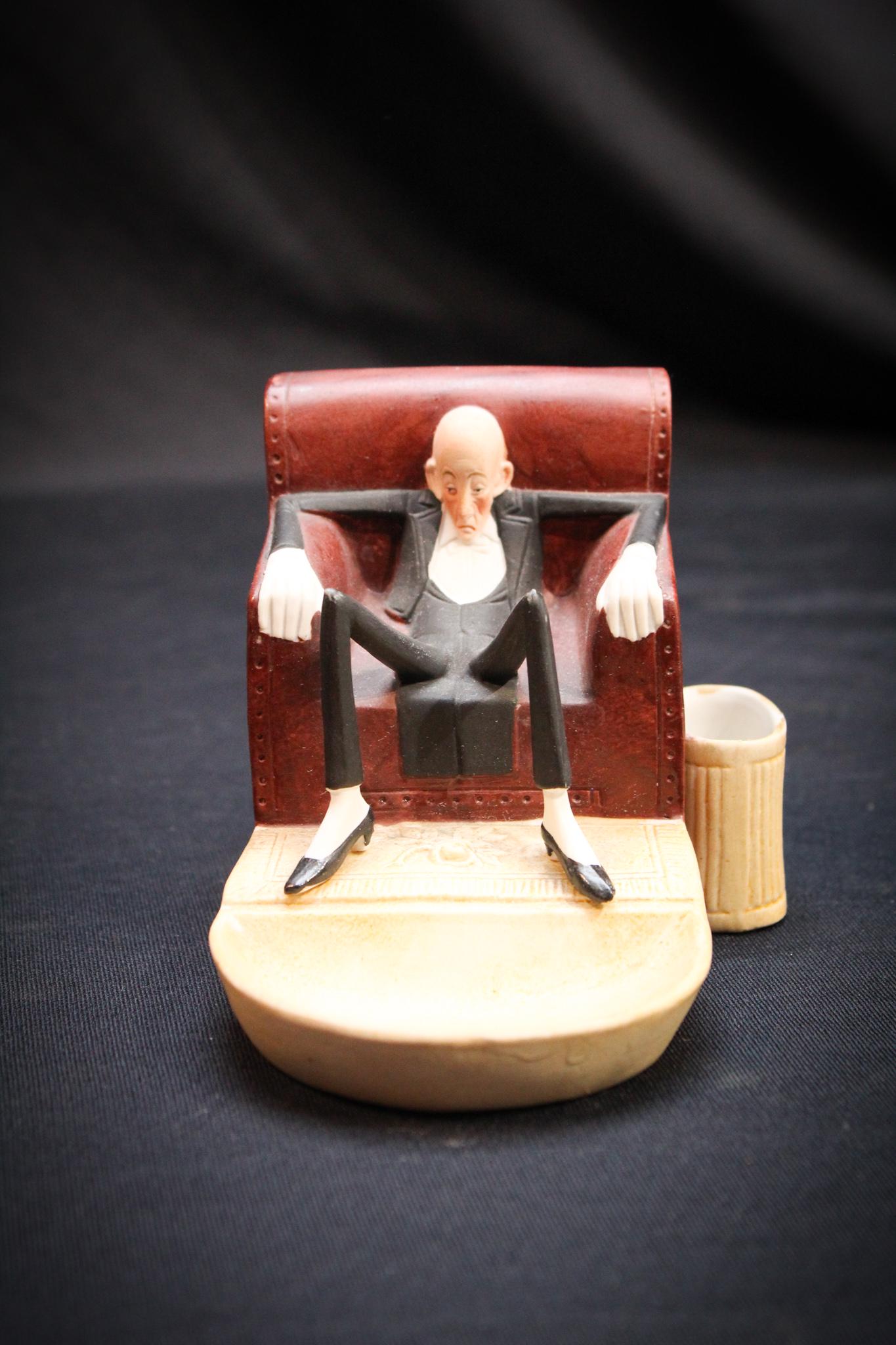 Schafer and Vader man in Chair Ashtray: Another charming piece by Schafer and Vader. Man relaxing in chair Match holder and ashtray. So comical. Measures 3" tall.