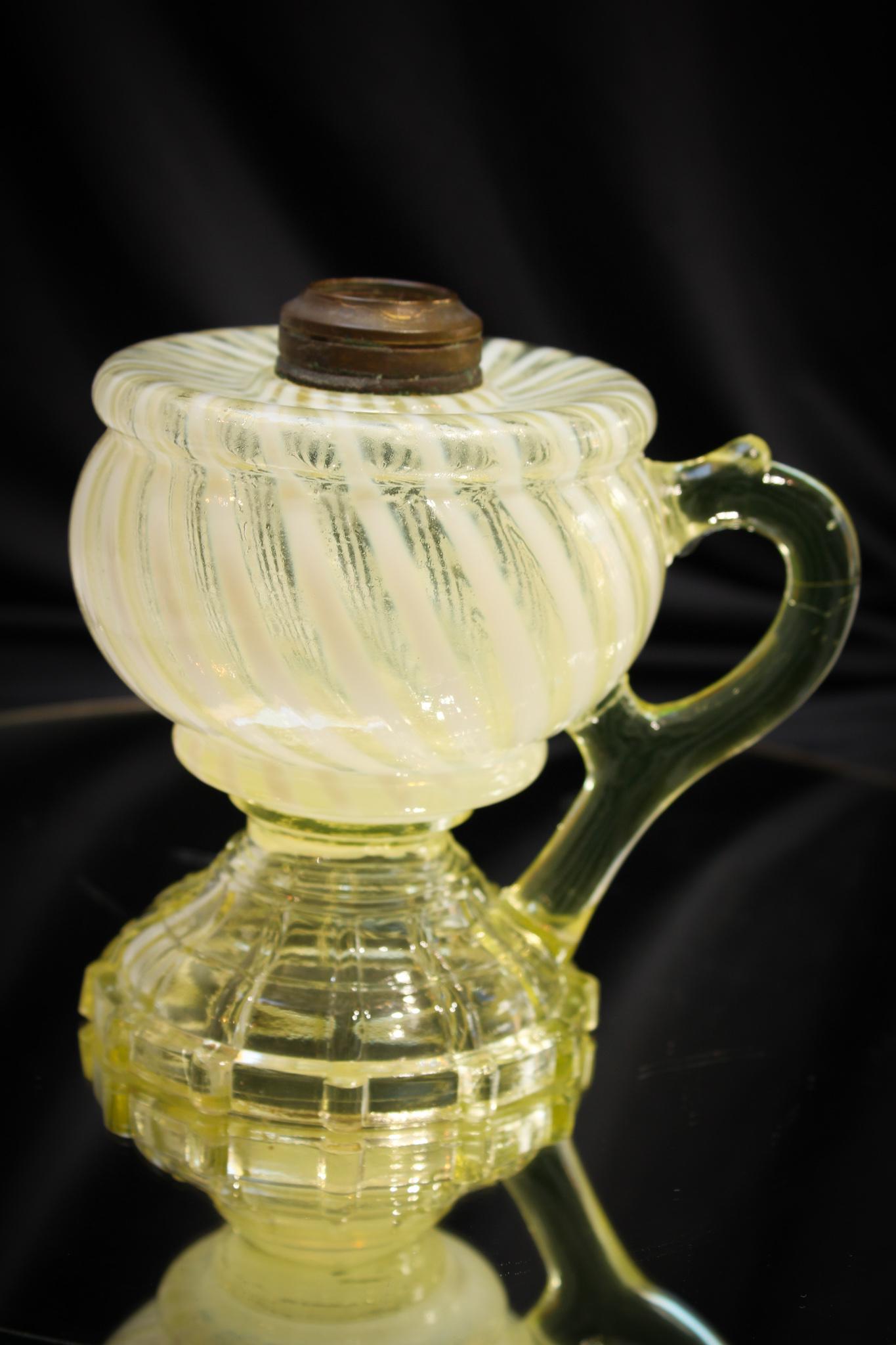 Vaseline Opalescent Swirl Finger Oil Lamp: Nice example of this lamp. Brilliant opalescence and flouresces under black light. Measures 5" tall.